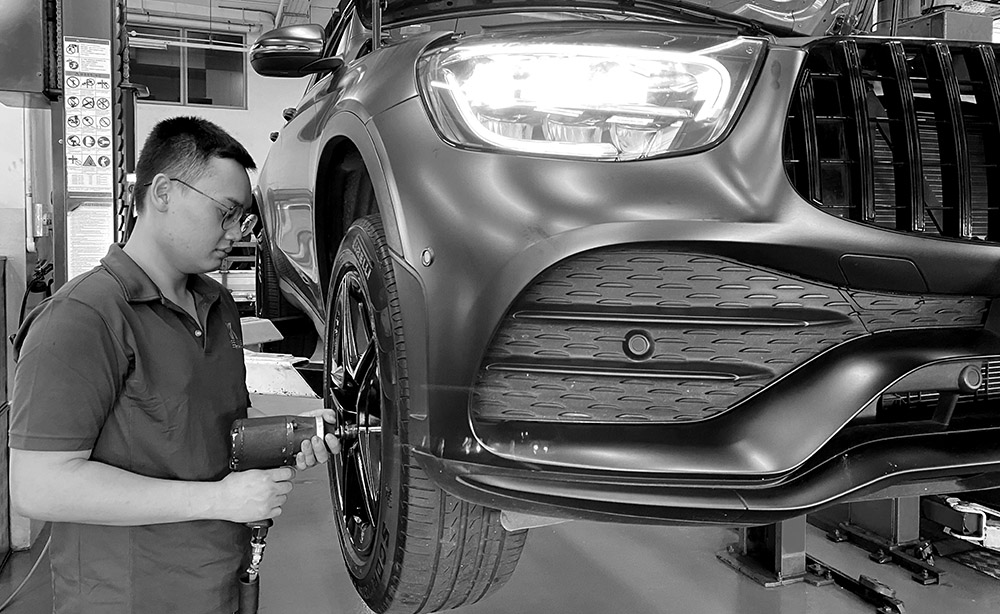 A Man Fixing The Tire Of A Car
