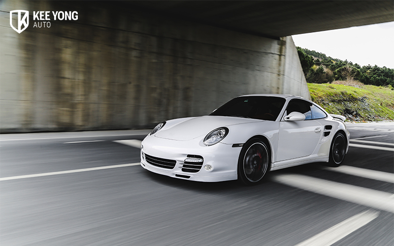 Image of someone driving a Porsche