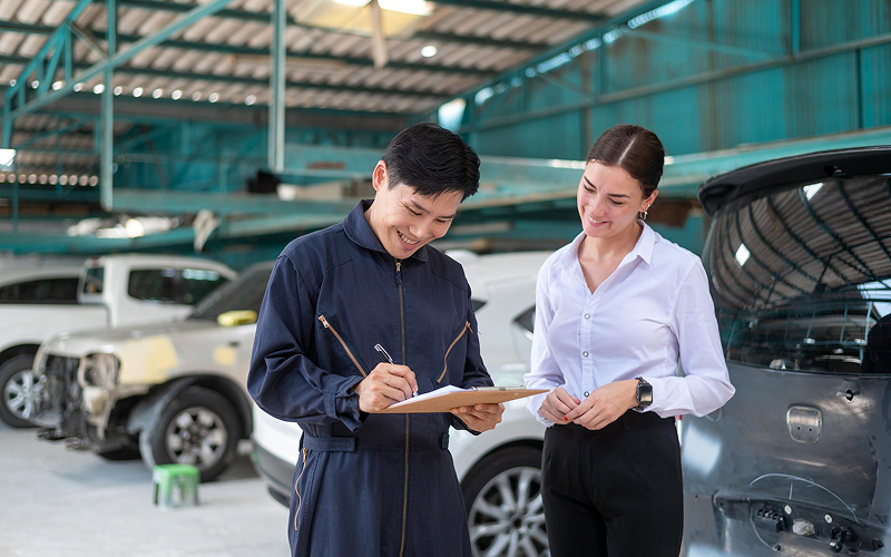 Car mechanic performing a car inspection check.